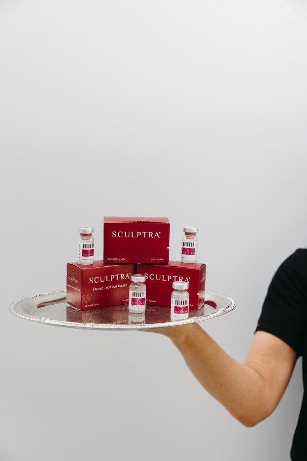 Sculptra vials and boxes presented on a silver tray at Anato Aesthetics